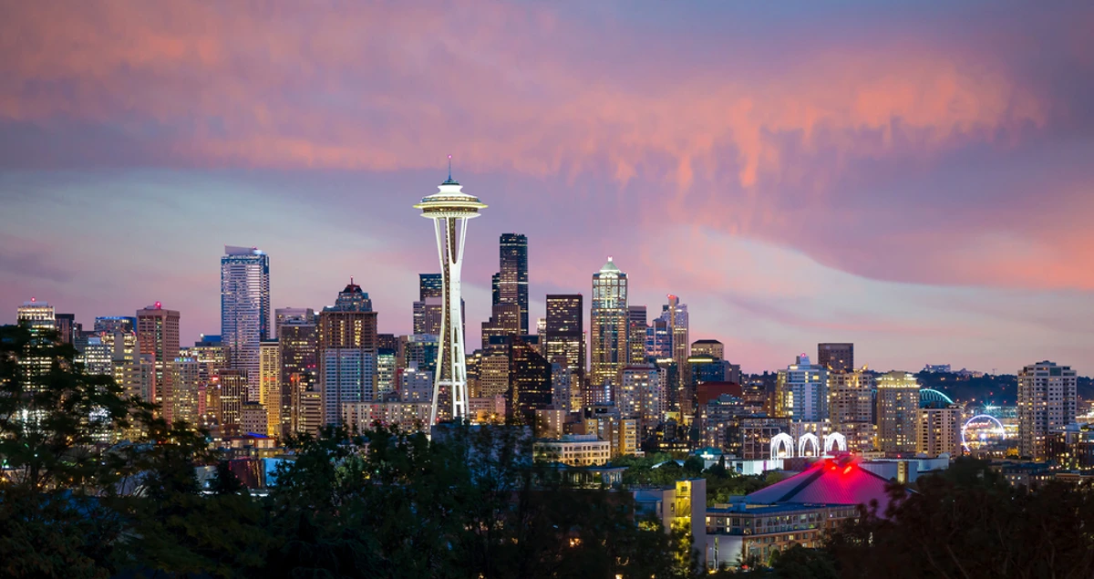 The Seattle skyline and Space Needle at dusk under a pink sky